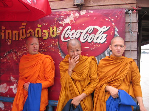 Monks in front of Coke sign