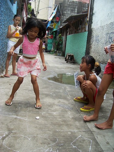 young girls playing a piko traditional game street scene Philippines Buhay 