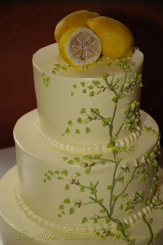 Pale yellow buttercream icing with spring green tree branches and foliage