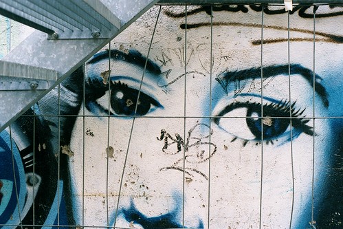 black and white graffiti of eyes watching the viewer