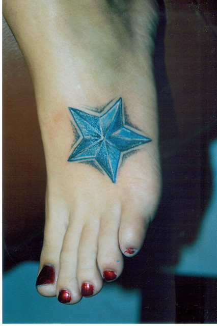 blue nautical star. female,top-o-foot tattoo . ouch! but she sat great ( the 