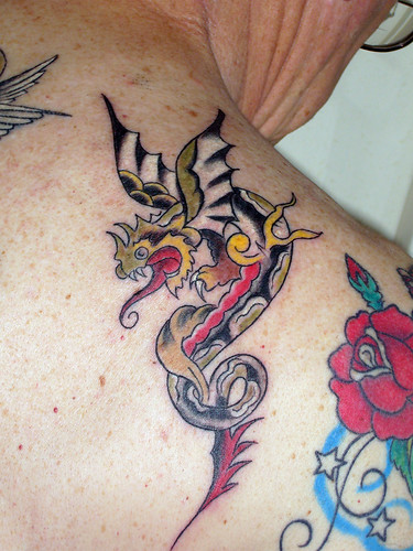 Here is a "Sailor Jerry" old school design featuring a small dragon tattoo.
