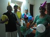 All of us wearing party hats and carrying matching coloured balloons for Appa's birthday