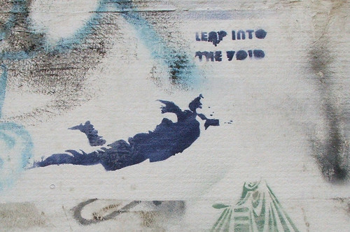 business-suited man, flying, next to the words, 'leap into the void'