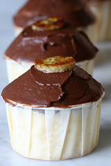 banana boston cream cupcakes topped with a caramelized banana chips