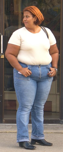 Fat big beautiful woman from Dominican Republic in tight jeans, T-shirt and shoes