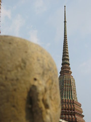 Statue looking at temple, Bangkok
