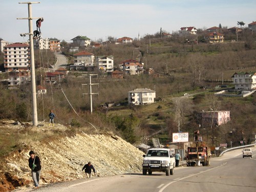The guys on the powerpole have no safetly line (safe work place near Akcakoca, Black Sea caost of Turkey)
