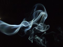 Incense smoke against a black sky
