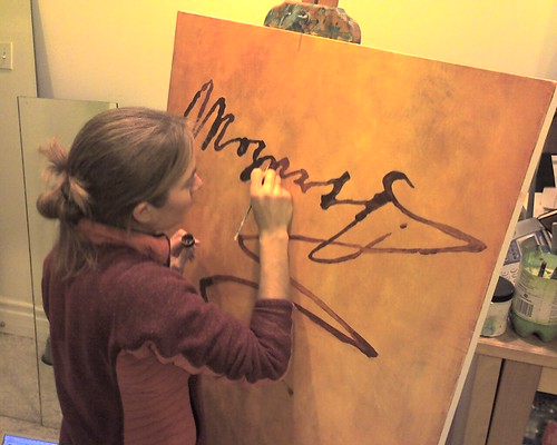 Kristin working on her latest and biggest Mozart painting