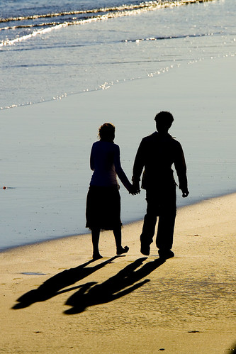 2 people walking on beach. 19, 2006 Two people walk
