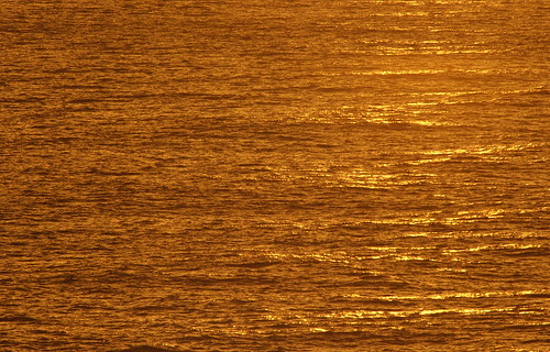 ocean water sunset. Golden-tinted ocean water
