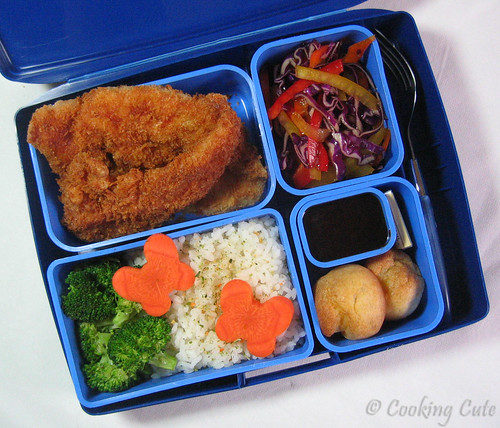 [laptop lunchbox with chicken katsu and tonkatsu sauce, veggie slaw, pastries, chocolate, veggies]