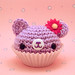 Amigurumi purple cupcake bear with flower