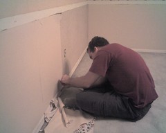 Kevin works on stripping some wallpaper