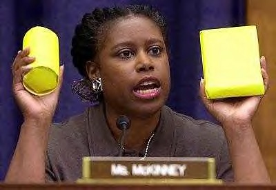 Former US Congresswoman from Georgia, Cynthia McKinney, holds up food packet and cluster bomb, both of which were being dropped on Afghanistan by the American military in late 2001. She ran as the  Green Party Presidential candidate in 2008. by Pan-African News Wire File Photos