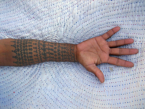 small hand tattoos. Tattooed forearm of a Rabari