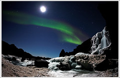 Moonshimmering waterfall and Aurora Borealis - by Arnar Valdimarsson