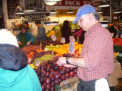 Slicing plums for samples for passersby at Sosio's Fruit & Produce, Pike Place Market