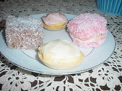 Lamington, two little iced cakes, a coconut-covered jelly cake