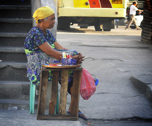 cigarette vendor cubao, quezon city, philippines old lady cigarette vendor sitting stationary side yosi solo alone street