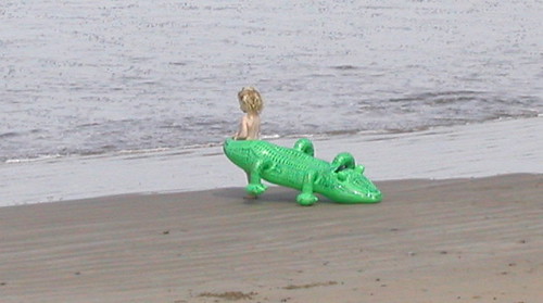 Topless babe with floatie toy