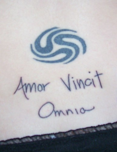 amor vincit omnia tattoo on back. amor vincit omnia calligraphy