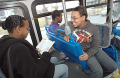 Aboard an Annapolis Transit bus, Chanica Massey (right) talks to Shawana Williams after handing her a brochure