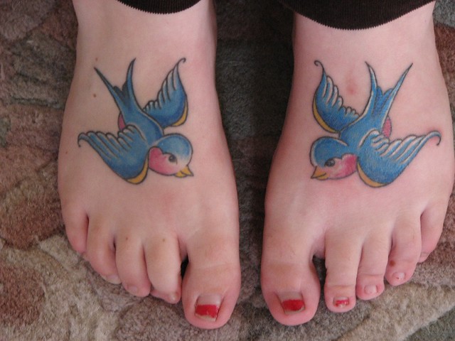 blue bird / swallows tattoos. these are my daughters tattooed feet. i read 