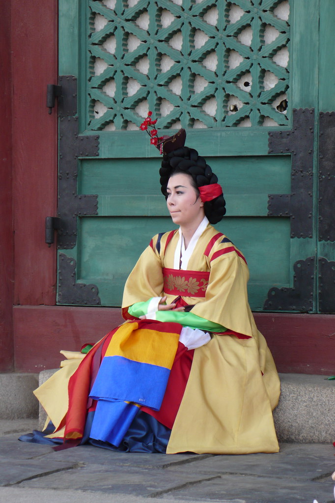 Lady performer in Traditional Korean dress preparing to go on stage