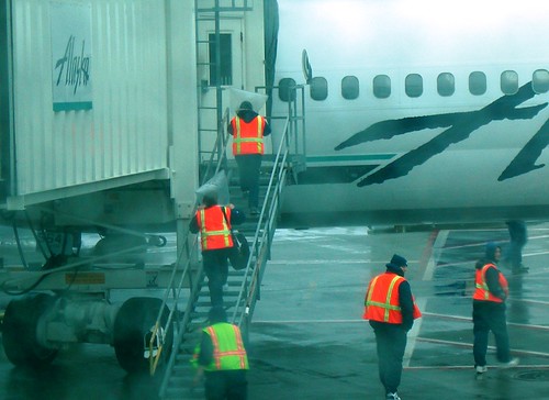 Alaska Airlines' Menzies Ground Crew with heads in plastic bags.