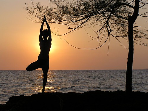 Wallpaper showing a yogi practising Sun Yoga at sunset
