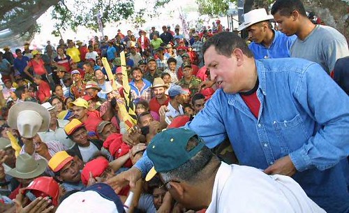 President Chavez handing out land titles to peasants in Venezuela. The Bolivarian Revolutionary government has extended home heating oil assistance to poor communities in the United States. by Pan-African News Wire File Photos