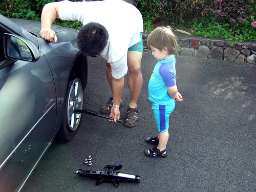 4. remove the lug nuts with the handle of the jack, using foot for leverage