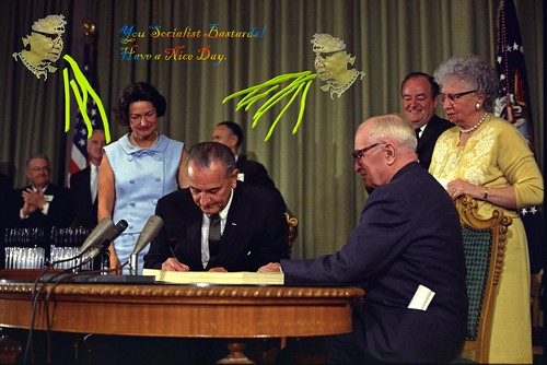 Lyndon Johnson signing Medicare bill, with Harry Truman, 30 July, 1965