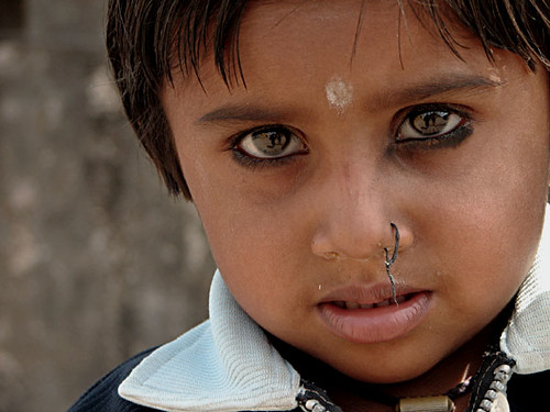 typical indian tradition of nose piercing in early age. the thread is kept 
