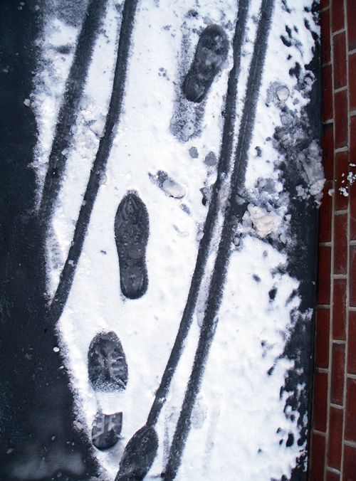 footprints and cart tracks in snow