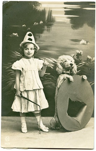 costumed child with trick dog