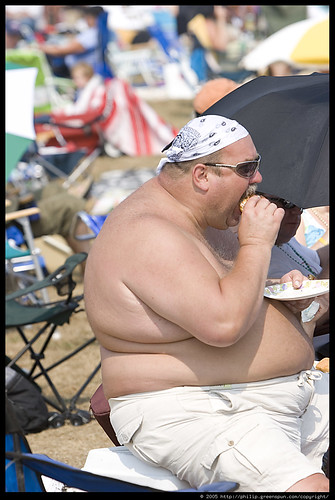 fat guy eating cheeseburger. fat-shirtless-guy-eating-