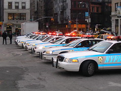 Row Of Police Cars With Flashing Lights