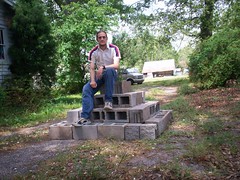Luca Masters sitting atop his cinderblock pyramid.