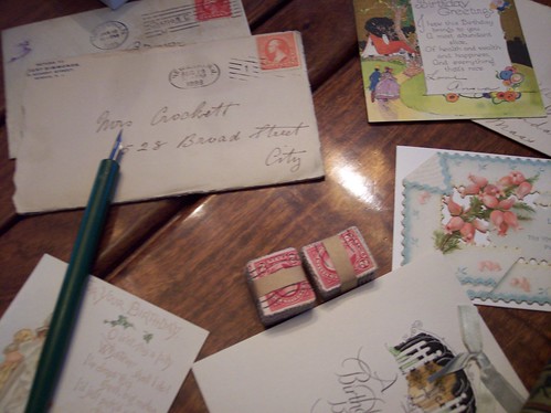 Vintage stationary, old letters, stacks of old stamps and an antique pen