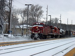 Eastbound Canadian Pacific freight train passing through Christmas card scenery. Photographed at the northwest suburban Metra River Grove Illinois commuter rail station.