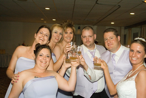 The Bride, Bride's Maids, and some Grooms' Men share a shot