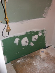 the new drywall covering the sink plumbing
