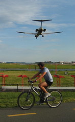 Cyclist admires jet