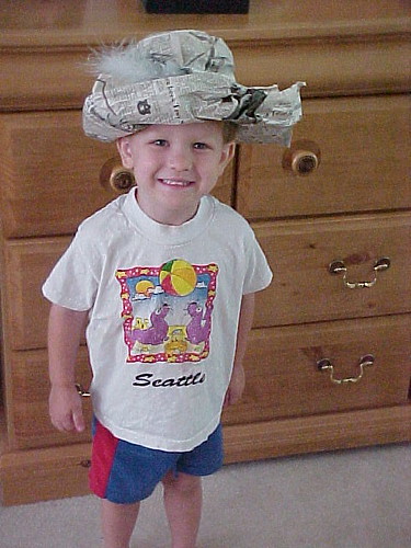 Playing dress up in his Newspaper Hat