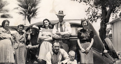 vintage: family gathering in front of old car,...