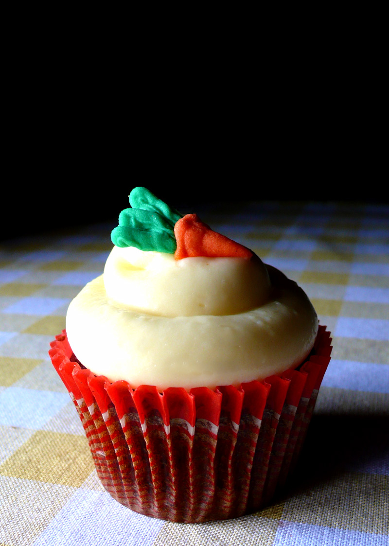a carrot cupcake with a cream cheese frosting