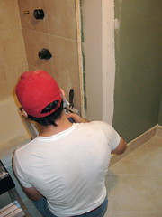 ken patching the drywall around the tub